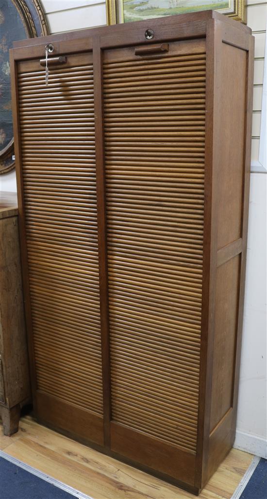 An oak double tambour shutter filing cabinet W.92cm